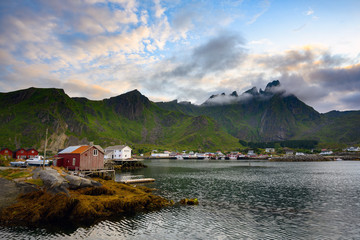 Waterfront cottage In the evening with the beautiful twilight light in the ballstad lofoten island, Northern Norway.