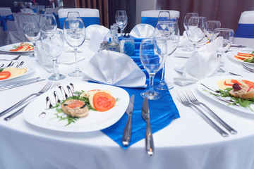 Tables and chairs in the restaurant with food and  full set preparation for dinner. Romantic dinner...