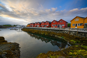 Beautiful waterfront house reflecting the water Evening and twilight sky at ballstad city, lofoten island in northern Norway. Rorbuer is the traditional home of Norwegian fishermen.