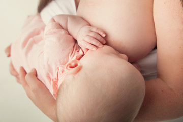 Breastfeeding baby held by mother