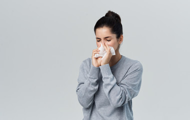woman blowing her nose