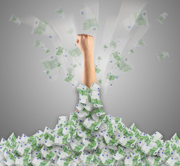 Human hand buried in euro pile and trying to break out