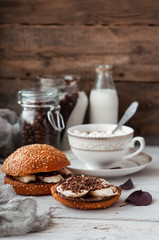 Obraz na płótnie Canvas sandwich with chocolate-milk paste, bananas and nuts with coffee on a white table