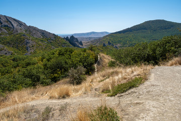 Summer Crimean landscape with mountains and the sea on a sunny day.