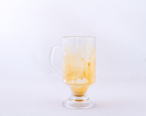 A used transparent glass coffee mug isolated on a white background image with copy space in horizontal format