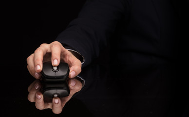 Hand using wireless mouse in a dark environment