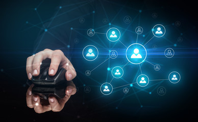 Hand using wireless mouse in a dark environment with human network concept