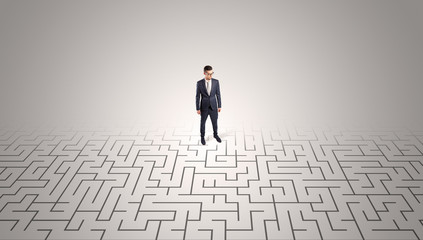 Elegant businessman looking for a solution in a middle of a maze