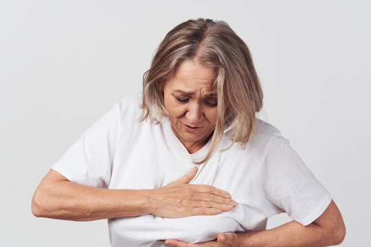 Senior Woman In Bed With Thermometer