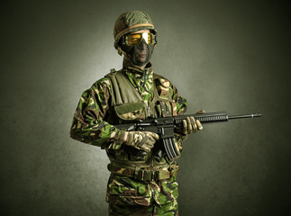 Soldier agent in a dark room with arms on his hand and gas mask