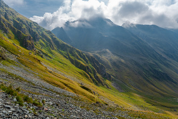 Wild mountain landscape with clouds. Fagaras Mountains, Romania