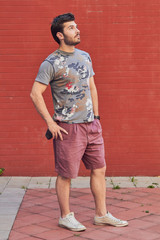 Young man posing in front of a camera.