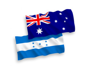 National vector fabric wave flags of Australia and Honduras isolated on white background. 1 to 2 proportion.