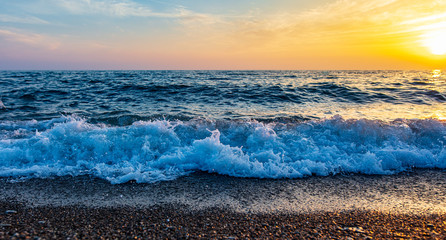 Waves on the seashore at sunset