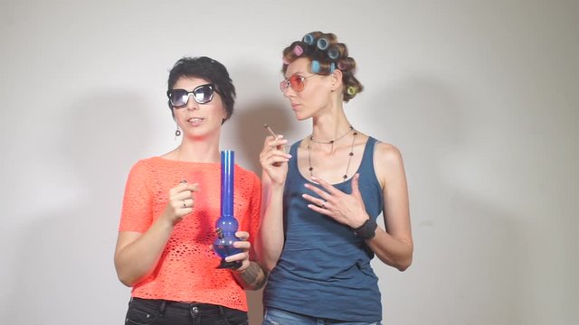 girl with a friend smokes cannabis in the toilet, at a corporate event