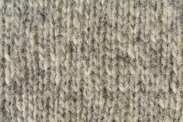 Knitted gray background. The texture of the knitted fabricю.