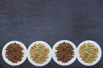 top view variety of roasted and green coffee beans on rustic background