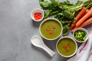 Healthy Vegan Creamy blended vegetable Soup puree with broccoli, celery, peas and carrots . Green detox soup concept. Low-fat lunch.
