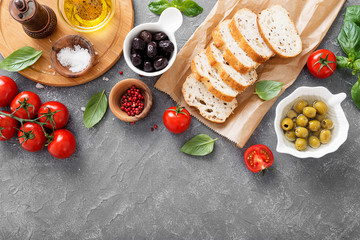 Italian food background.Sliced ciabatta bread with olives and basil. Italian cuisine concept.