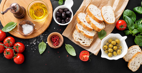 Italian food background.Sliced ciabatta bread with olives and basil. Italian cuisine concept.