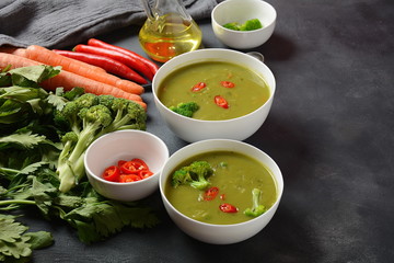 Healthy Vegan Creamy blended vegetable Soup puree with broccoli, celery, peas and carrots . Green detox soup concept. Low-fat lunch