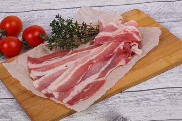 Raw bacon on the board