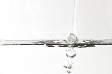 water splashing out of a glass isolated on white background