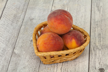 Peach heap in the wooden basket