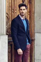 Obraz premium Attractive man wearing british elegant suit in the street. Modern hairstyle.