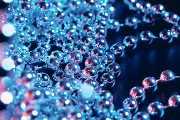 Party or holiday decoration concept - close up of silver shiny beads