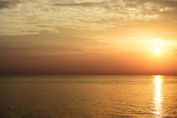 Fototapeta na wymiar Magnificent sunrise over the sea and beautiful cloudscape on the coast of Sicily. Cefalu, Italy