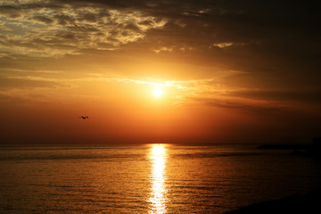 Magnificent sunrise over the sea and beautiful cloudscape on the coast of Sicily. Cefalu, Italy