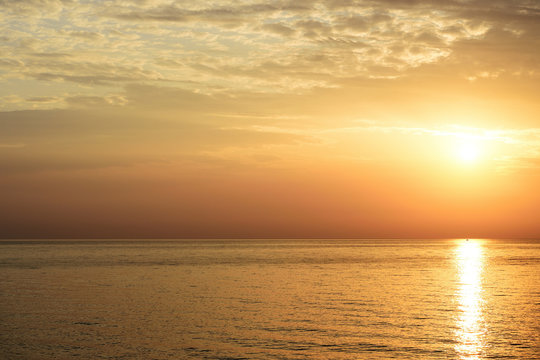 Magnificent sunrise over the sea and beautiful cloudscape on the coast of Sicily. Cefalu, Italy