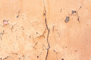 Old cracked wall, orange paint with cracks