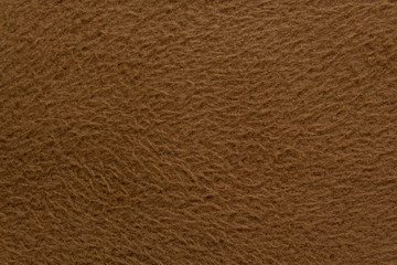 Texture of brown fleece fabric close up, fabric background