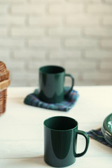 Green plastic kitchenware on a table close up