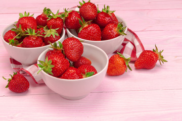 Plate of strawberry on pink wooden background