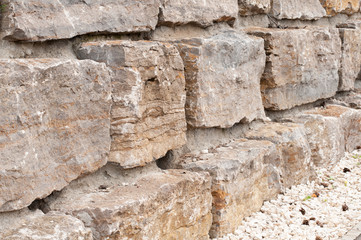 side view to old wall of limestone blocks