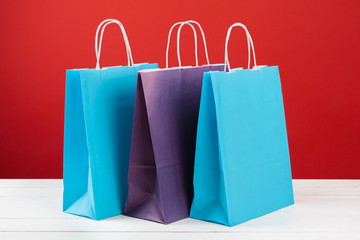 Paper shopping bags with copy space on red background