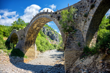 Old Kalogeriko triple arched stone bridge on Vikos canyon, Zagorohoria, Greece
