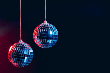 Obraz premium Sparkling disco balls hanging in the air against black background