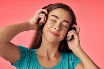 Fototapeta premium young woman listening to music on headphones
