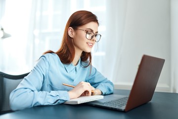 young woman working on laptop at home