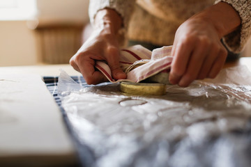 Hands of master with molds on clay on table