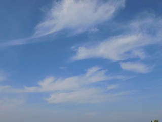 High blue summer sky with white fluffy clouds.