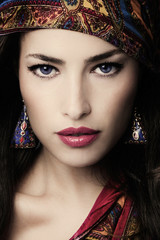 beautiful young woman portrait in oriental style with colorful scarf and earrings