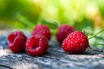 Ripe, freshly picked raspberries, on rustic wooden old surface. Selective focus