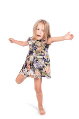 Little girl standing on one leg, stretching hand, isolated on a white background.