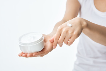 woman applying cream on her face
