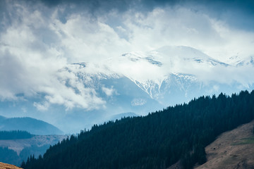 Naklejka na ściany i meble Foggy hills and gloomy mood of the scene of the alpine valley.
